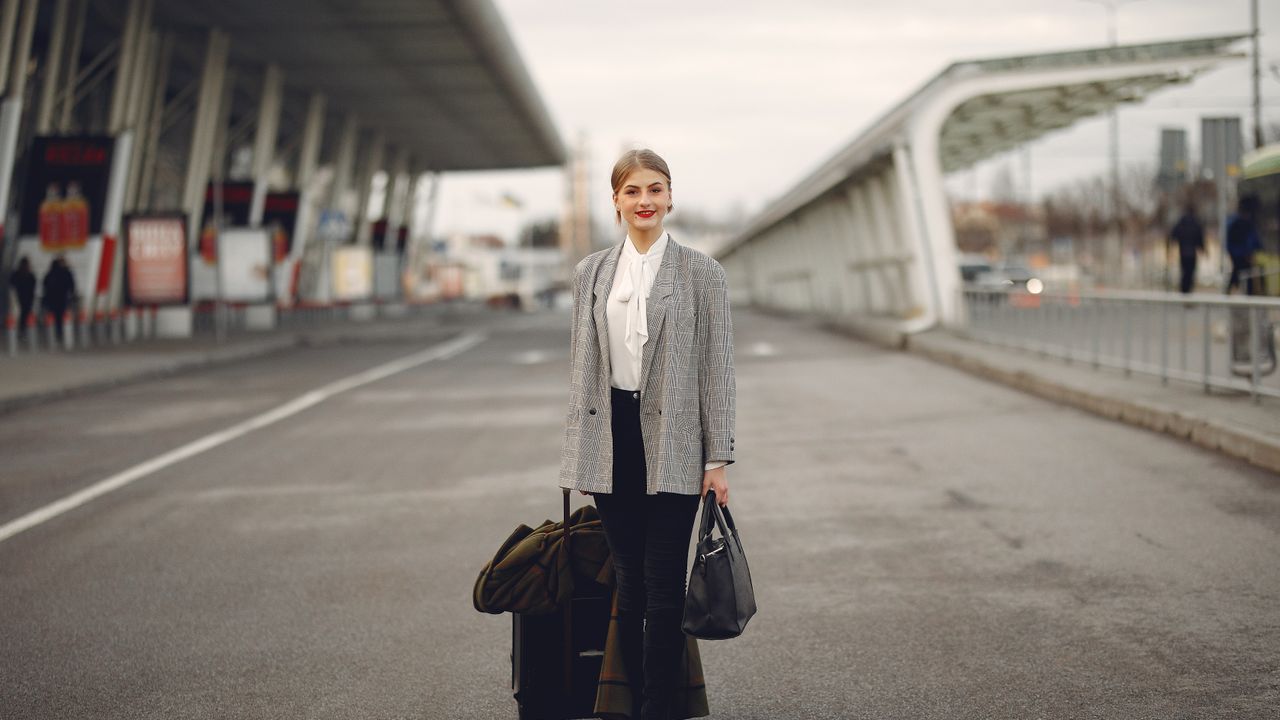 Reisende am Flughafen-Terminal mit Gepäck — pünktliche Abholung
